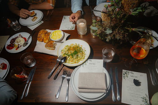 Dining table set with plates and drinks at Hinchcliff House