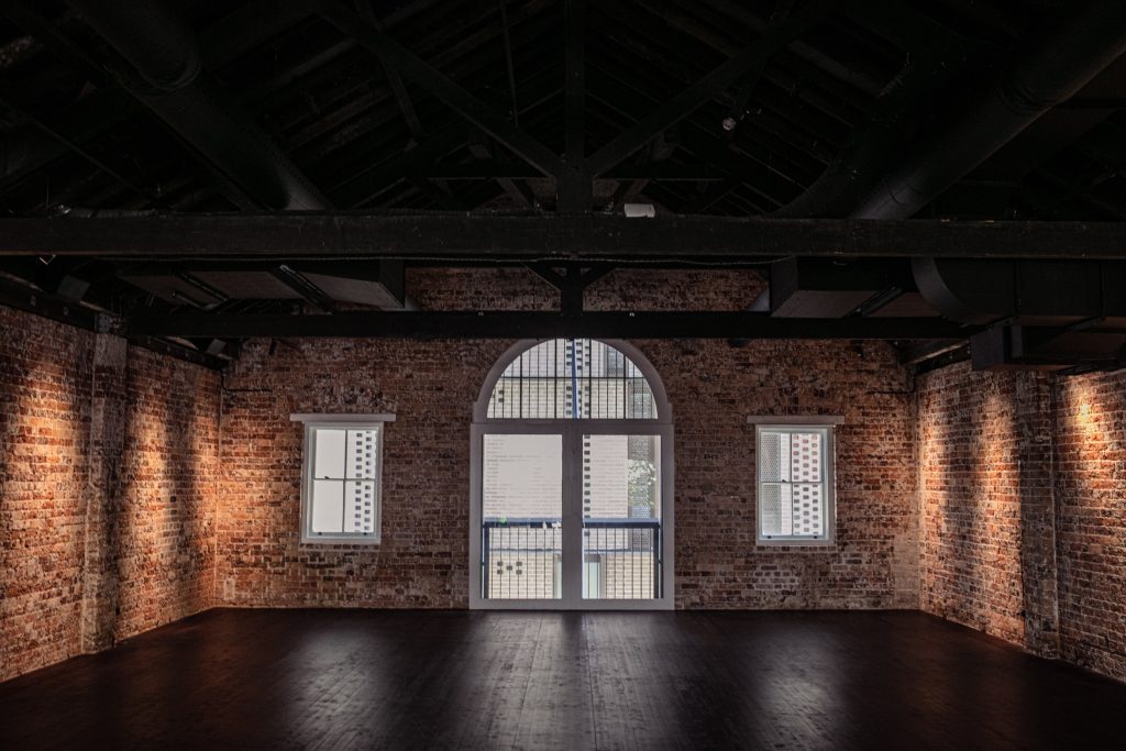 Level Two private event space with brick walls and arched window